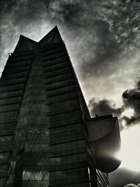 Low angle view of building against cloudy sky