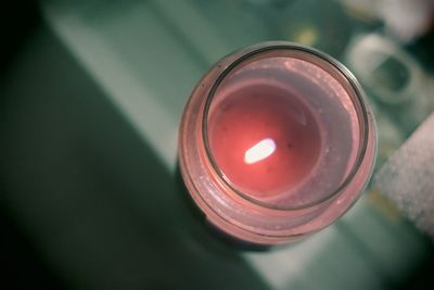 Close-up of lit tea light candle on table