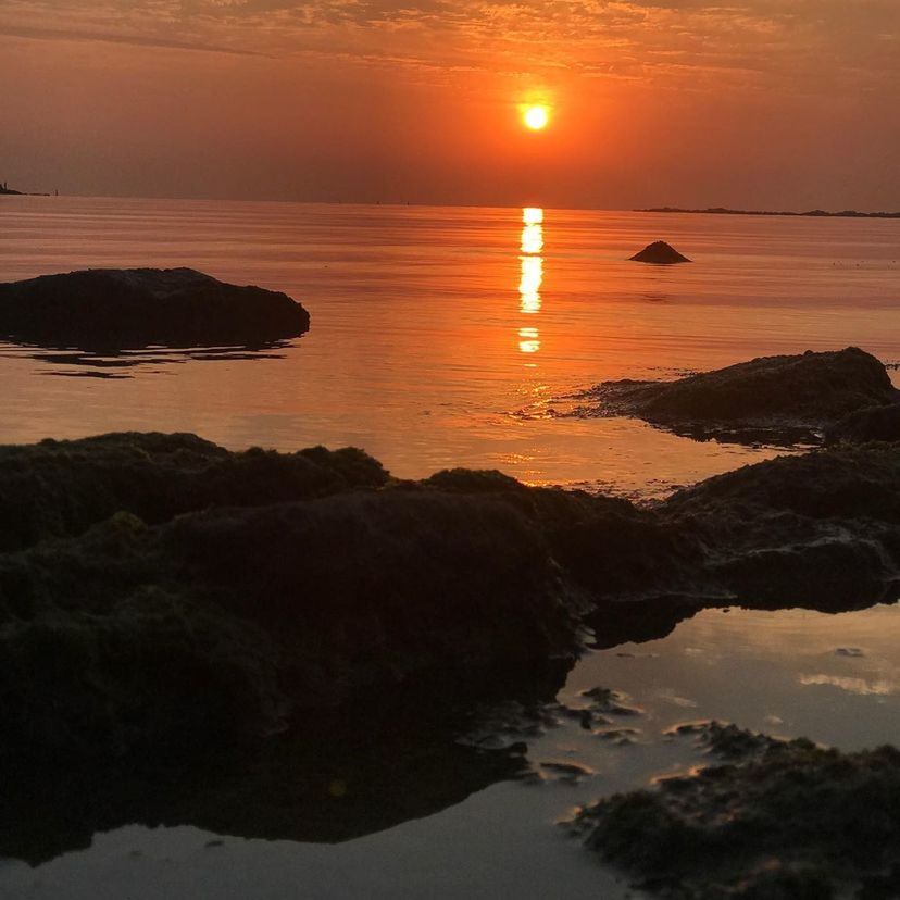 SCENIC VIEW OF SEA AGAINST ORANGE SKY