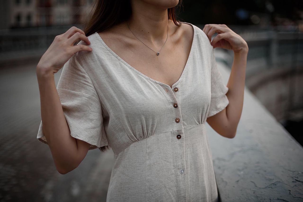 MIDSECTION OF WOMAN STANDING IN FRONT OF A BEAUTIFUL YOUNG MAN