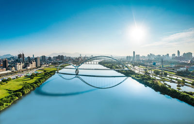 Aerial view of swimming pool by buildings against sky