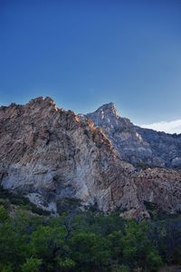 Scenic view of mountains against clear blue sky