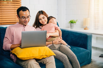 Young woman using laptop at home