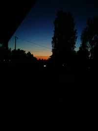 Silhouette of trees against sky at sunset