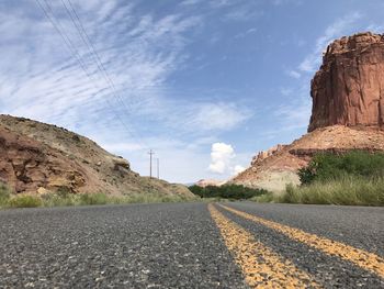 Road amidst rocks against sky