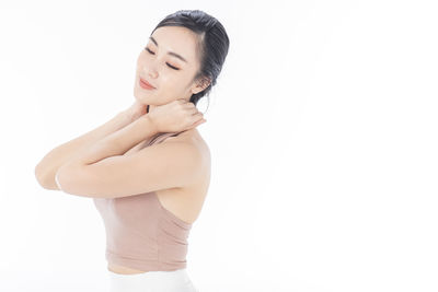 Woman standing against white background