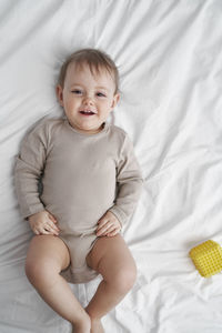 Carefree girl lying on bed at home