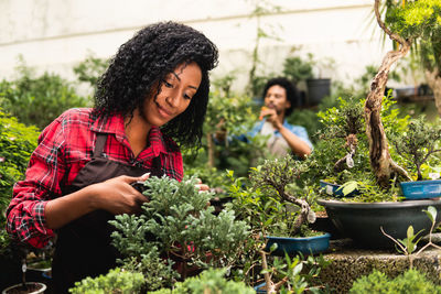 Young woman holding potted plant