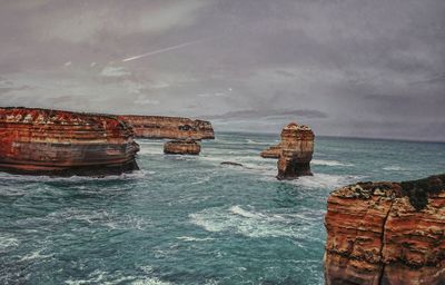 Scenic view of sea against cloudy sky