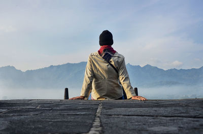 Rear view of man standing on mountain