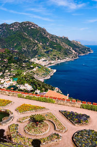 High angle view of sea and mountains against sky