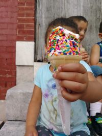 Midsection of woman holding ice cream