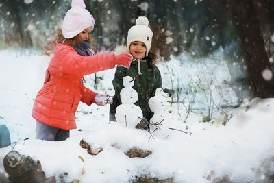 Girls making snowman