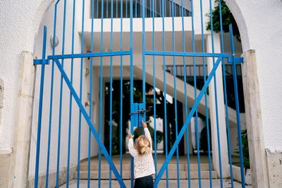 High angle view of young woman standing on wall