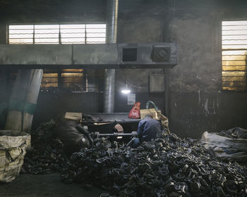 Man working with garbage on floor