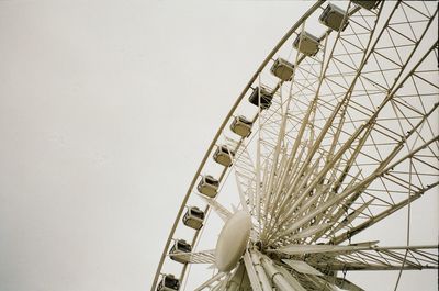 Low angle view of ferris wheel against sky