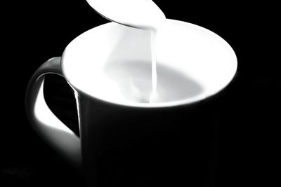 Close-up of coffee cup against black background