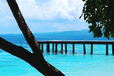 Scenic view of swimming pool by sea against sky