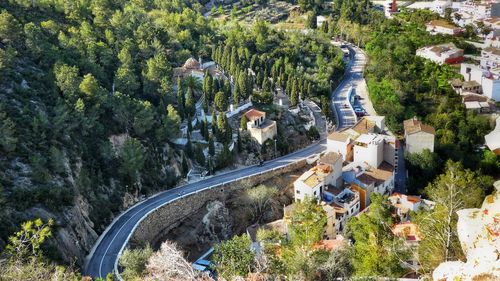 High angle view of road amidst trees and buildings