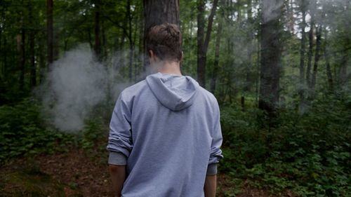 Rear view of man in forest