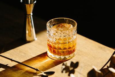 Close-up of glass with bourbon whiskey on table