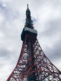 Low angle view of communications tower against cloudy sky