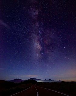 Road against sky at night