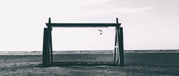 Lifeguard hut on beach against clear sky