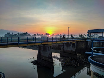 Bridge over river against sky untill sunrise