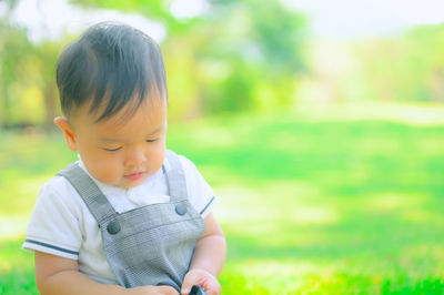 Cute boy looking away on field