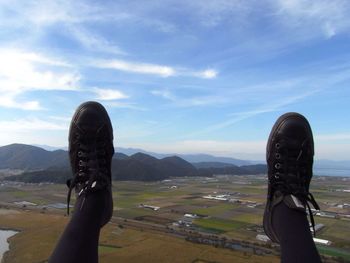 Low section of woman against mountain range