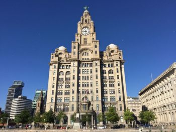 Low angle view of buildings against blue sky