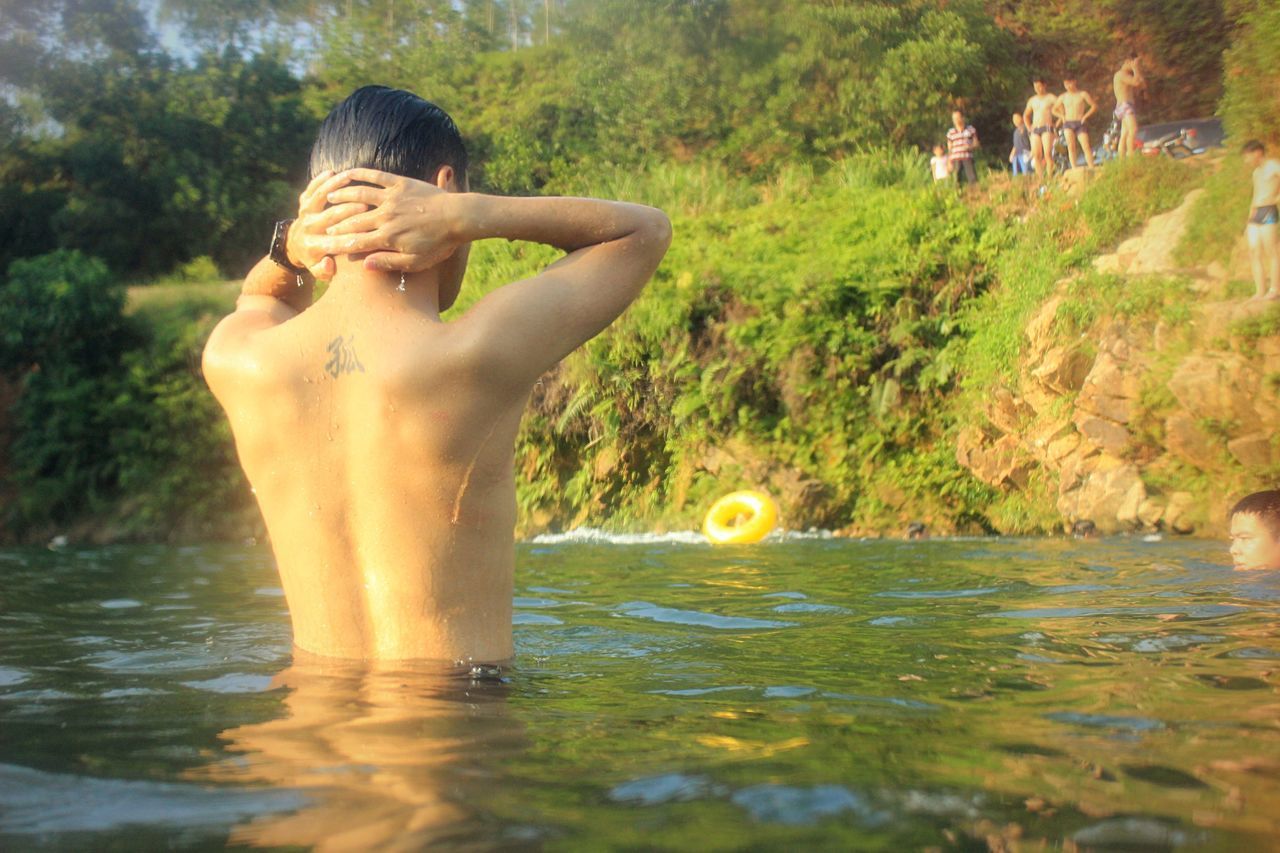 water, young adult, waterfront, person, human representation, statue, sculpture, art, tree, art and craft, young women, shirtless, creativity, lifestyles, front view, leisure activity, reflection