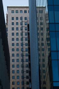 Low angle view of modern buildings against clear blue sky