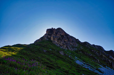 Low angle view of mountain against clear blue sky