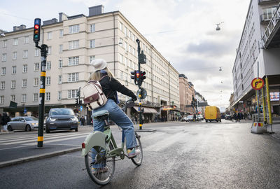 Woman cycling in city