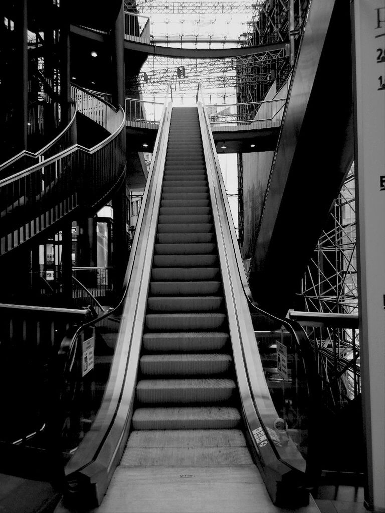 built structure, architecture, railing, steps and staircases, the way forward, staircase, steps, transportation, diminishing perspective, connection, low angle view, indoors, escalator, bridge - man made structure, footbridge, vanishing point, stairs, building exterior, day, high angle view