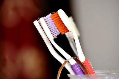 Close-up of toothbrushes in container