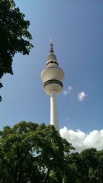 Low angle view of communications tower against blue sky