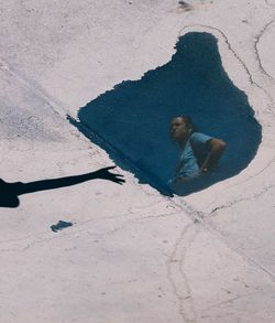 High angle view of man shadow on sand