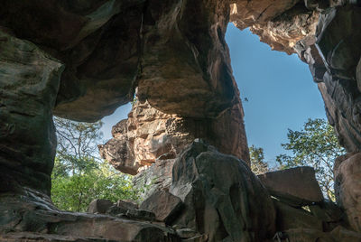 Low angle view of rock formation against sky