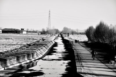 Panoramic view of road by city against clear sky