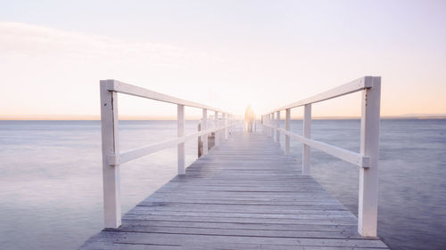 Pier over sea against sky