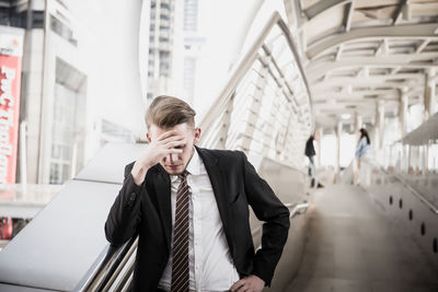 Worried businessman standing in city