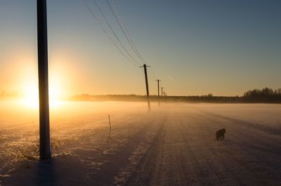 Scenic view of snow field against sky during sunset