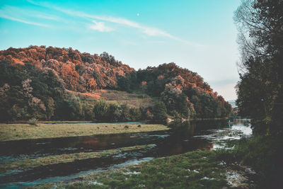 Scenic view of river against sky during autumn