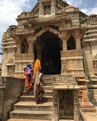 Low angle view of women at temple entrance