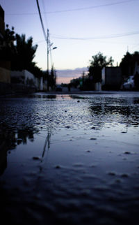 Surface level of wet city at sunset