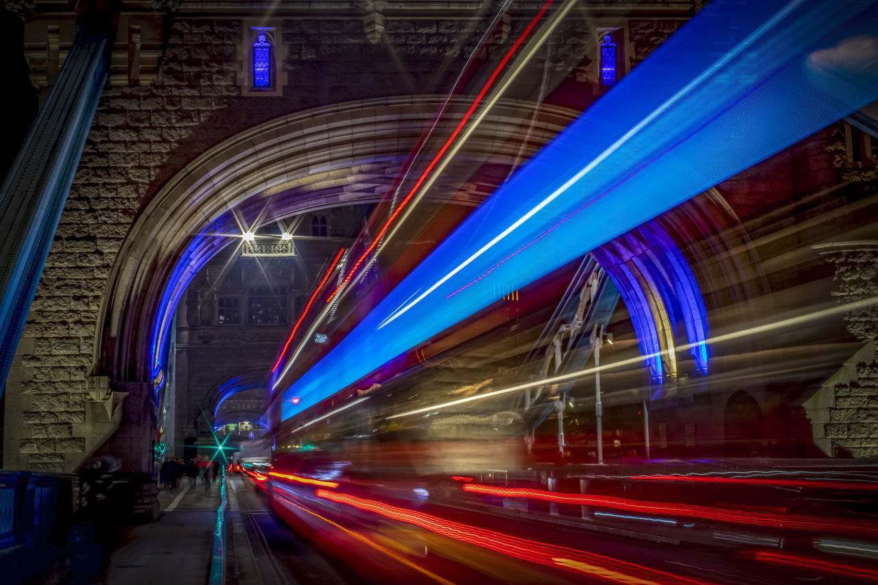 LIGHT TRAILS ON STREET AT NIGHT