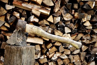 Axe against stack of logs